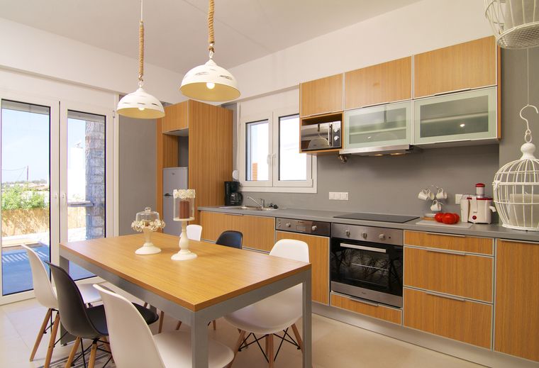 Open kitchen with dining table at Villa Aada