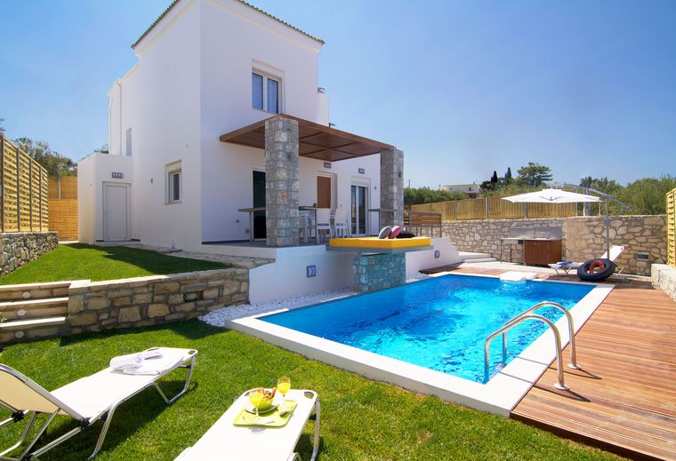 Villa Aada pool and sun loungers by day