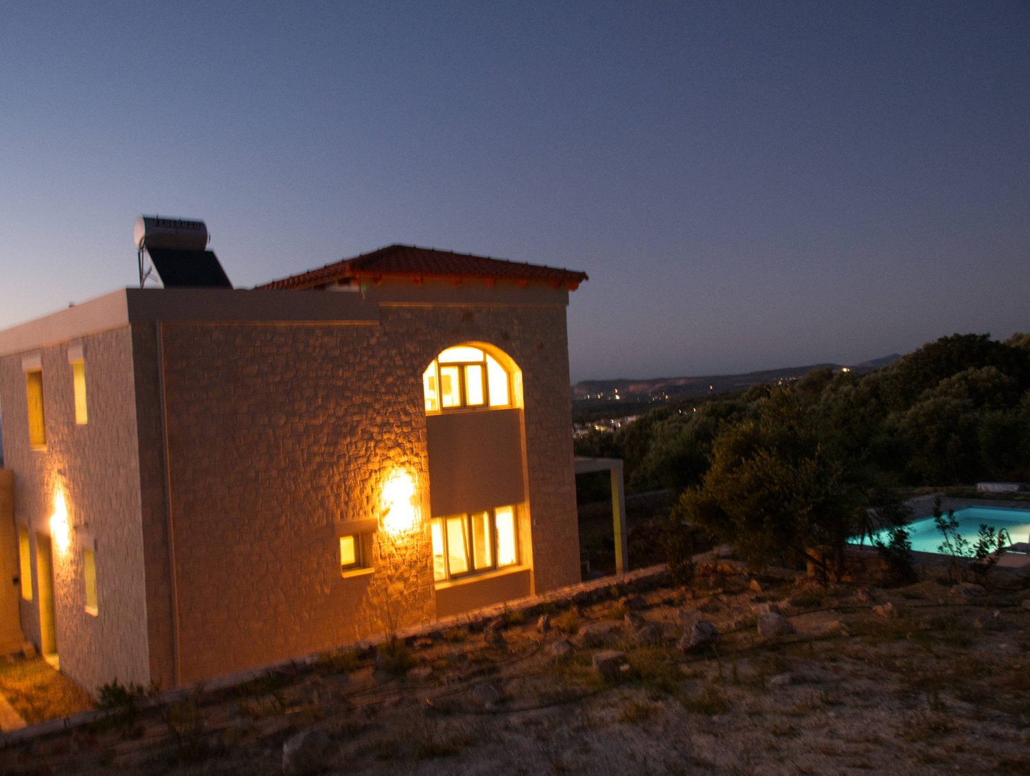 Villa Eos at dusk with lit windows