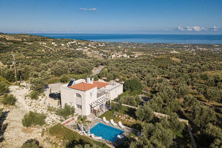 Aerial view: Villa Eos and pool amid olive groves