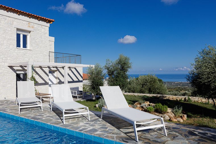 Villa Eos pool with sun loungers, the Aegean beyond