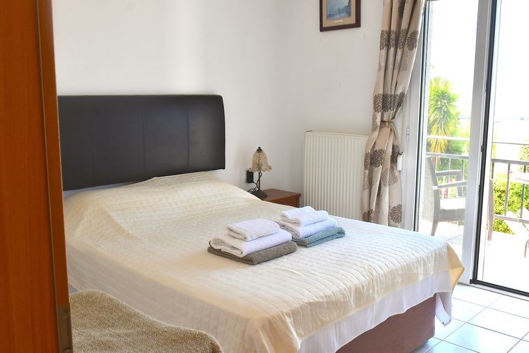 Villa Mailin bedroom with double bed and access to the balcony